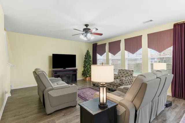 a living room with furniture a large bed and a chandelier