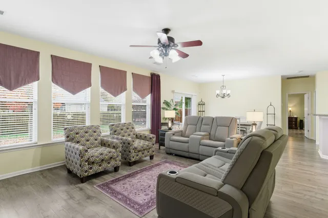 a living room with furniture and a chandelier