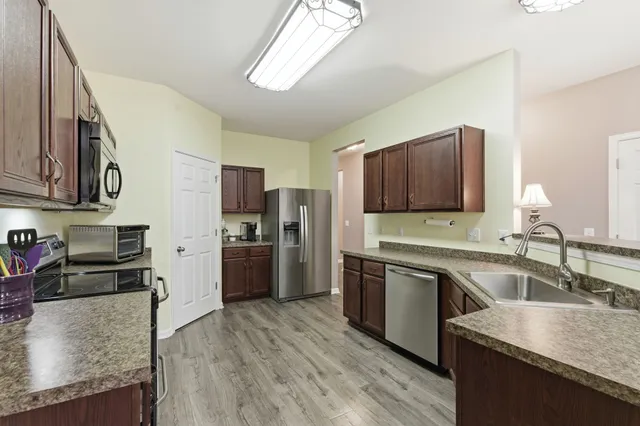 a view of a dining room with furniture wooden floor and chandelier