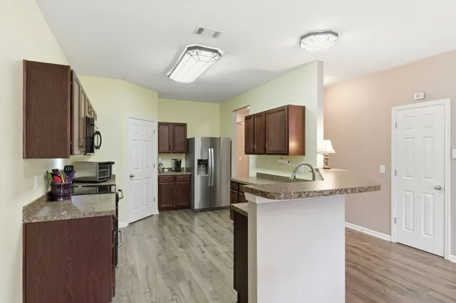 a view of a dining room with furniture wooden floor and chandelier