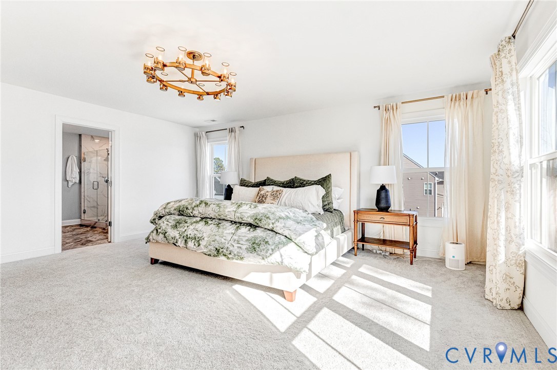 17101 Westington Road Moseley, VA 23120 - Photo 31 of 50 a spacious bedroom with a bed and a chandelier