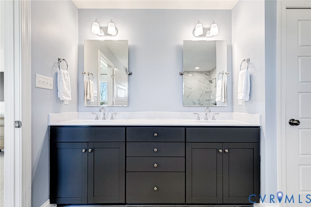 17101 Westington Road Moseley, VA 23120 - Photo 36 of 50 a bathroom with a double vanity sink and mirror