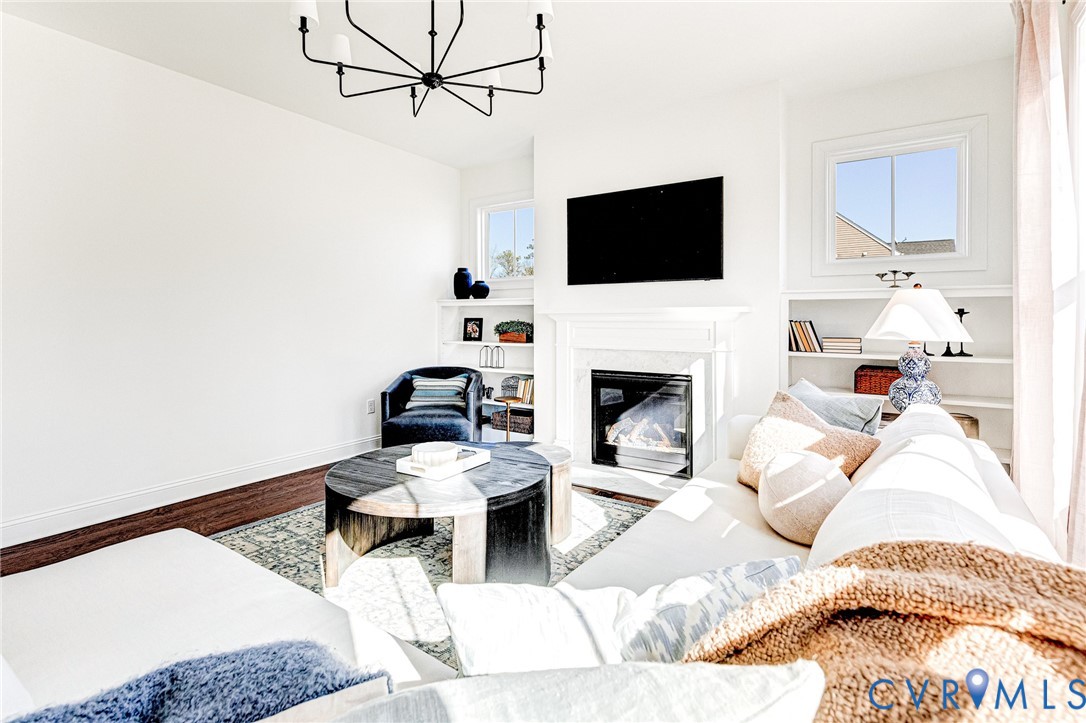 17101 Westington Road Moseley, VA 23120 - Photo 7 of 50 a living room with furniture a flat screen tv and a fireplace
