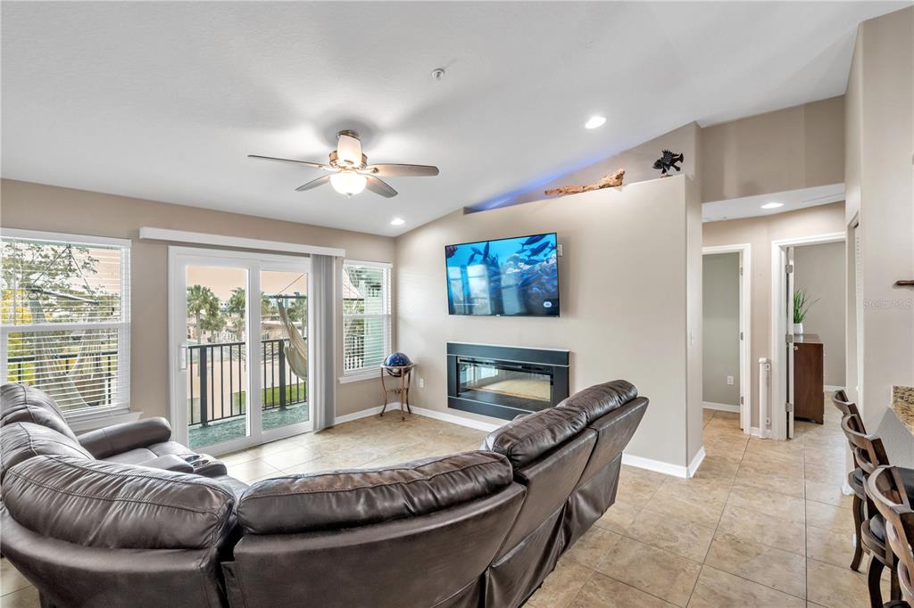 6420 Banyan Boulevard, Unit 303 New Port Richey, FL 34652 - Photo 12 of 54 a living room with furniture and a fireplace