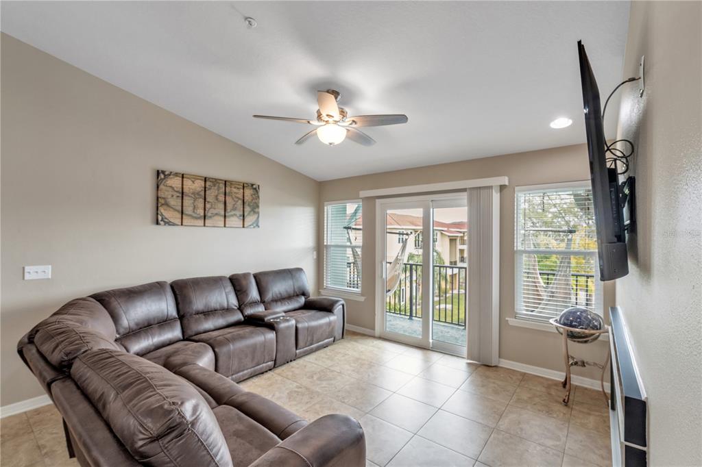 6420 Banyan Boulevard, Unit 303 New Port Richey, FL 34652 - Photo 13 of 54 a living room with furniture and a flat screen tv