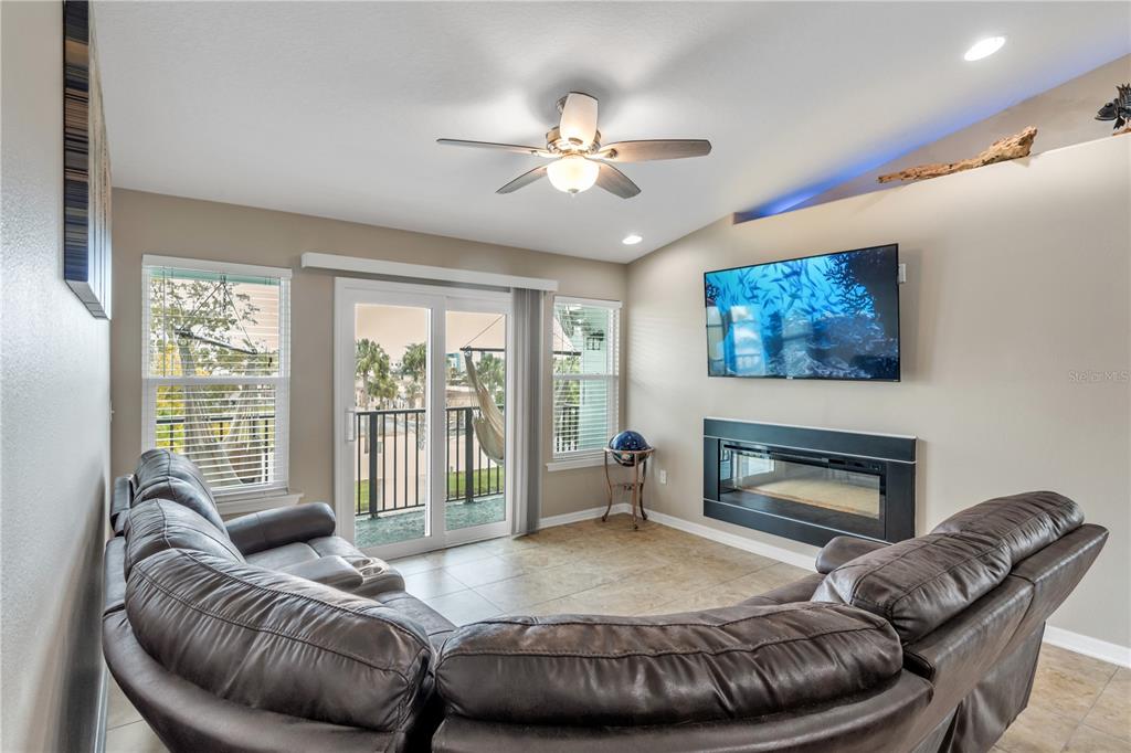 6420 Banyan Boulevard, Unit 303 New Port Richey, FL 34652 - Photo 15 of 54 a living room with furniture and a fireplace
