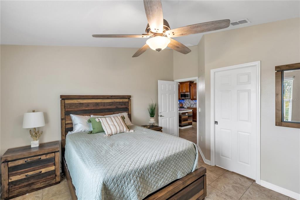 6420 Banyan Boulevard, Unit 303 New Port Richey, FL 34652 - Photo 17 of 54 a bedroom with a bed and a chandelier