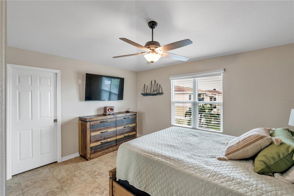 6420 Banyan Boulevard, Unit 303 New Port Richey, FL 34652 - Photo 18 of 54 a bedroom with a bed and a flat screen tv