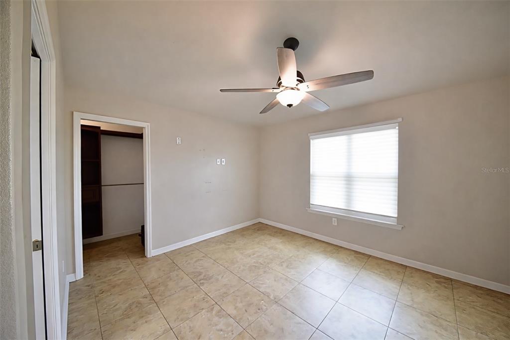 6420 Banyan Boulevard, Unit 303 New Port Richey, FL 34652 - Photo 19 of 54 an empty room with fan and windows