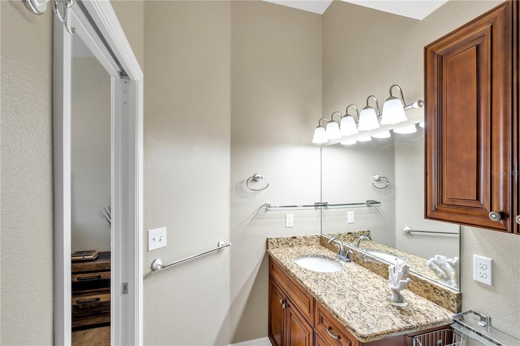 6420 Banyan Boulevard, Unit 303 New Port Richey, FL 34652 - Photo 20 of 54 a bathroom with a granite countertop sink and a mirror