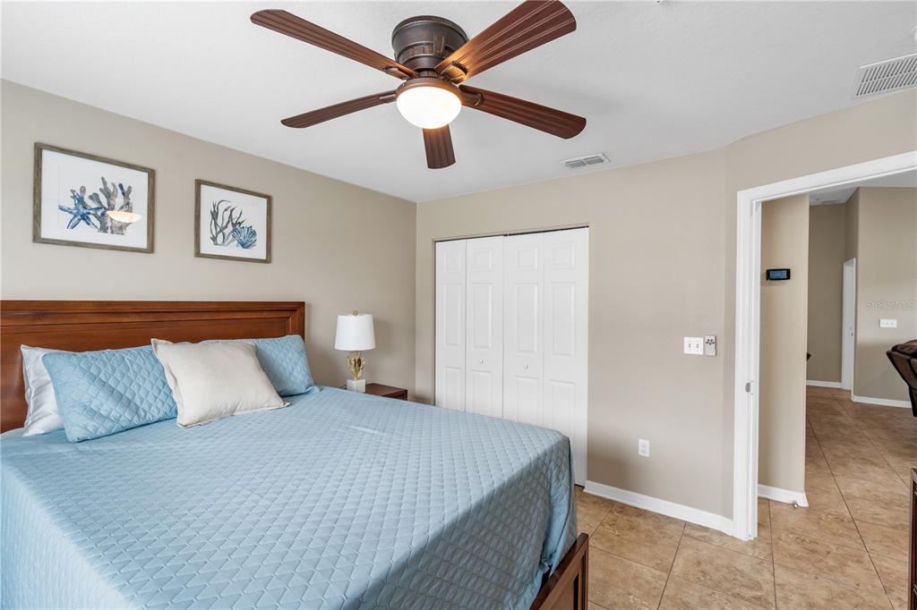 6420 Banyan Boulevard, Unit 303 New Port Richey, FL 34652 - Photo 22 of 54 a bedroom with a large bed and a chandelier