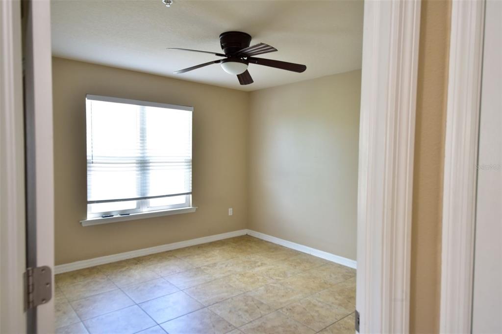 6420 Banyan Boulevard, Unit 303 New Port Richey, FL 34652 - Photo 24 of 54 a view of empty room with ceiling fan