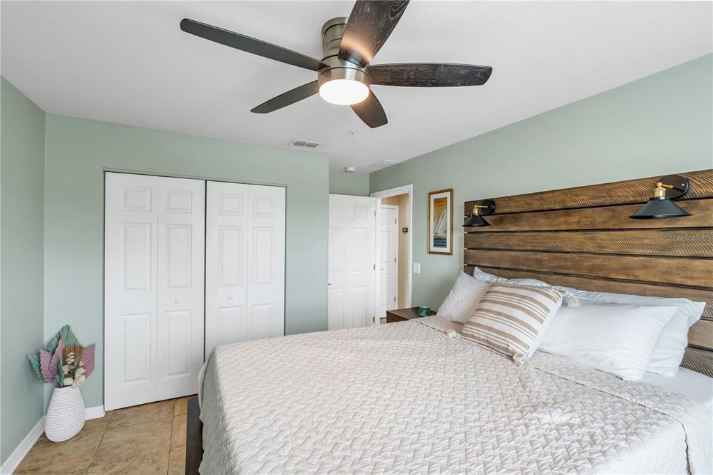 6420 Banyan Boulevard, Unit 303 New Port Richey, FL 34652 - Photo 26 of 54 a bedroom with a bed and a ceiling fan