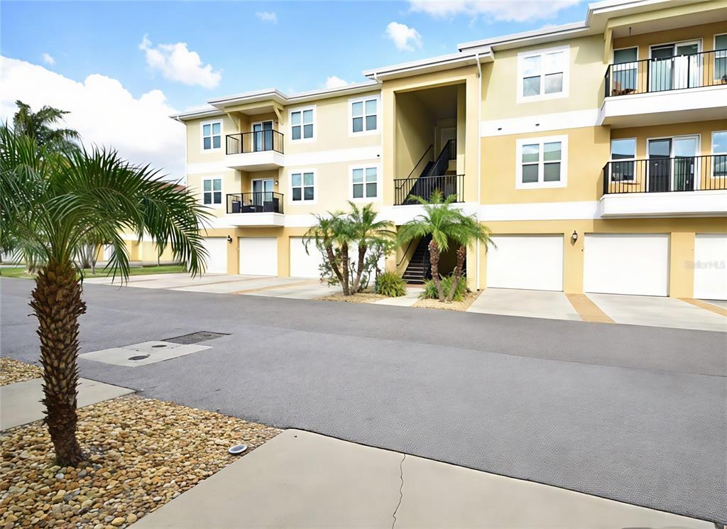 6420 Banyan Boulevard, Unit 303 New Port Richey, FL 34652 - Photo 3 of 54 a front view of a house with a garden