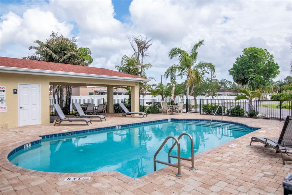 6420 Banyan Boulevard, Unit 303 New Port Richey, FL 34652 - Photo 35 of 54 a view of swimming pool with outdoor seating and plants