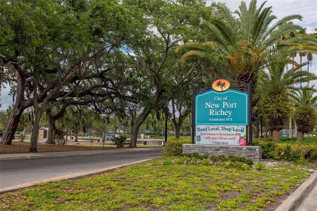 6420 Banyan Boulevard, Unit 303 New Port Richey, FL 34652 - Photo 49 of 54 a sign board with tall trees