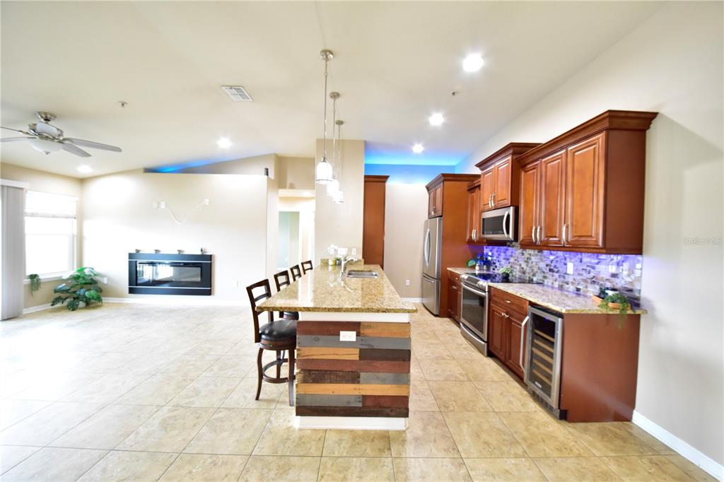 6420 Banyan Boulevard, Unit 303 New Port Richey, FL 34652 - Photo 5 of 54 a kitchen with stainless steel appliances kitchen island granite countertop a stove and cabinets