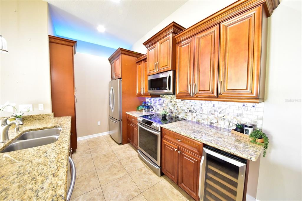 6420 Banyan Boulevard, Unit 303 New Port Richey, FL 34652 - Photo 9 of 54 a kitchen with a sink stove and cabinets