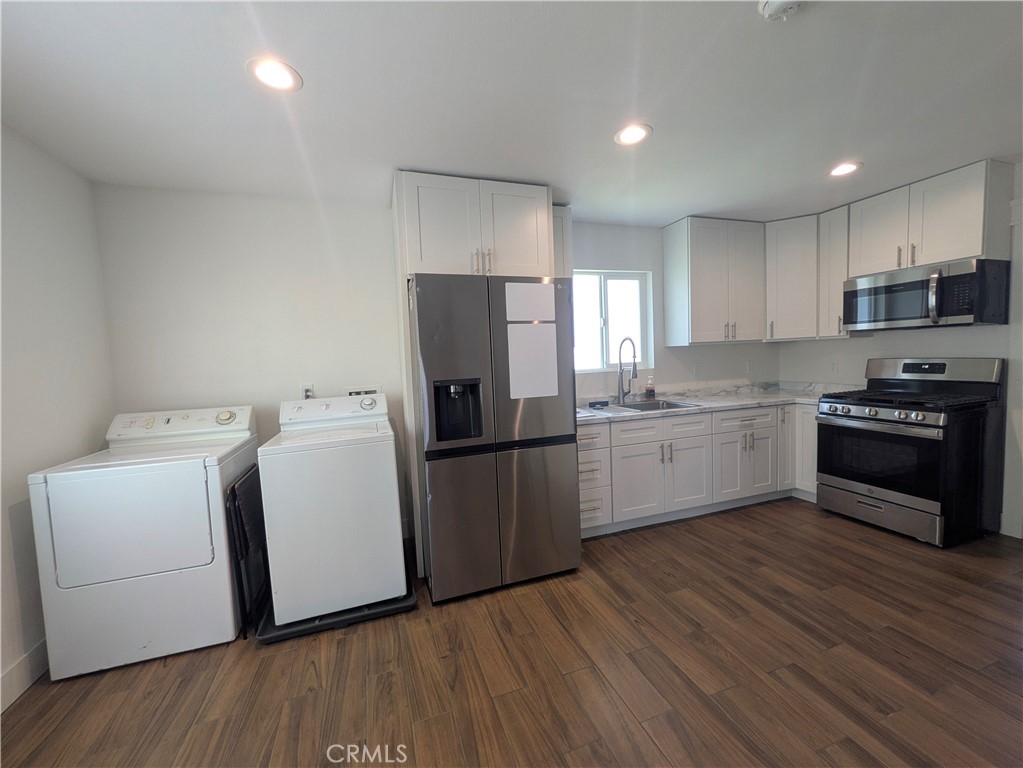 4803 Beatty Drive Riverside, CA 92506 - Photo 3 of 5 a kitchen with a sink a refrigerator a microwave and cabinets