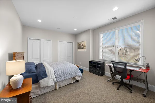 a living room with lots of furniture and gym equipment