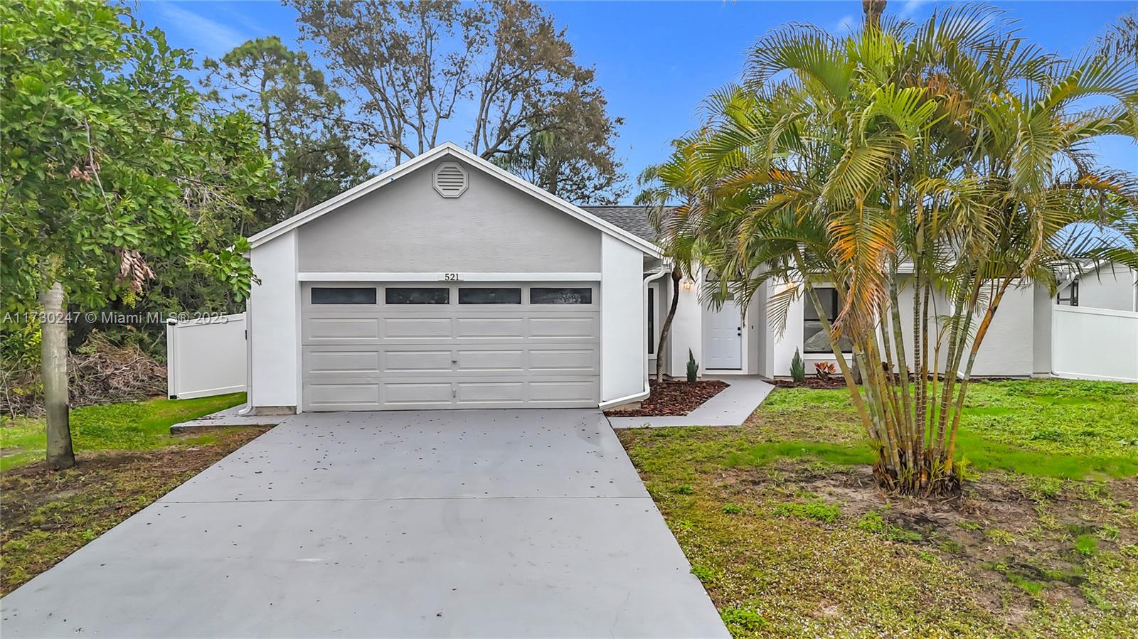 521 Southwest Rabbit Avenue Port St. Lucie, FL 34953 - Photo 12 of 45 a view of a small space in front of a house with a yard