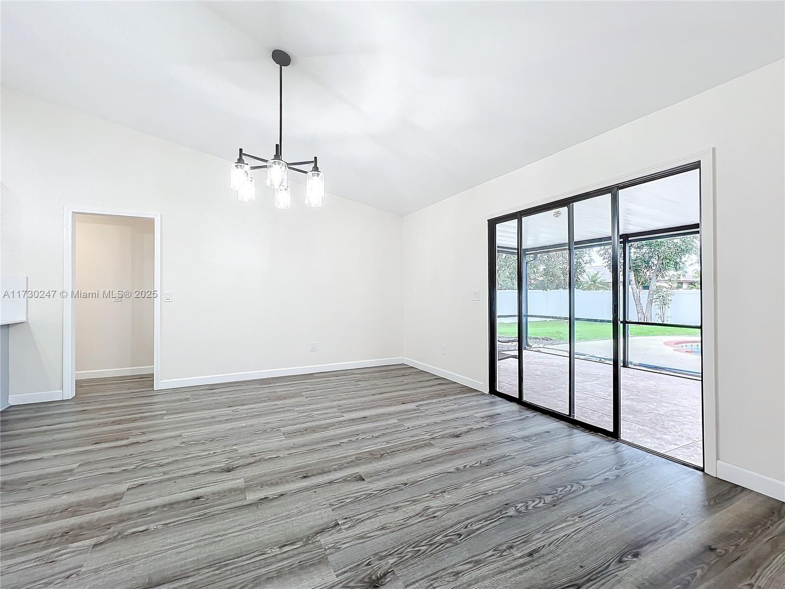 521 Southwest Rabbit Avenue Port St. Lucie, FL 34953 - Photo 25 of 45 a view of an empty room with wooden floor and a window