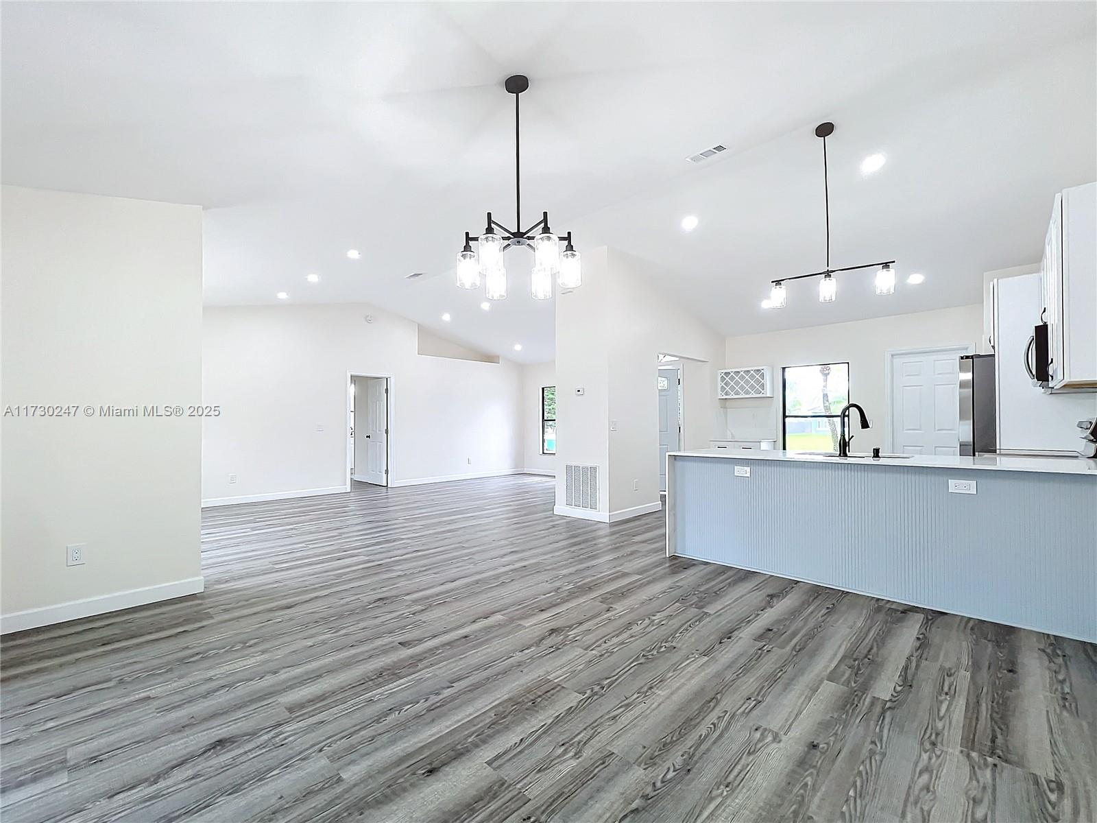 521 Southwest Rabbit Avenue Port St. Lucie, FL 34953 - Photo 27 of 45 a view of a kitchen with a sink and wooden floor