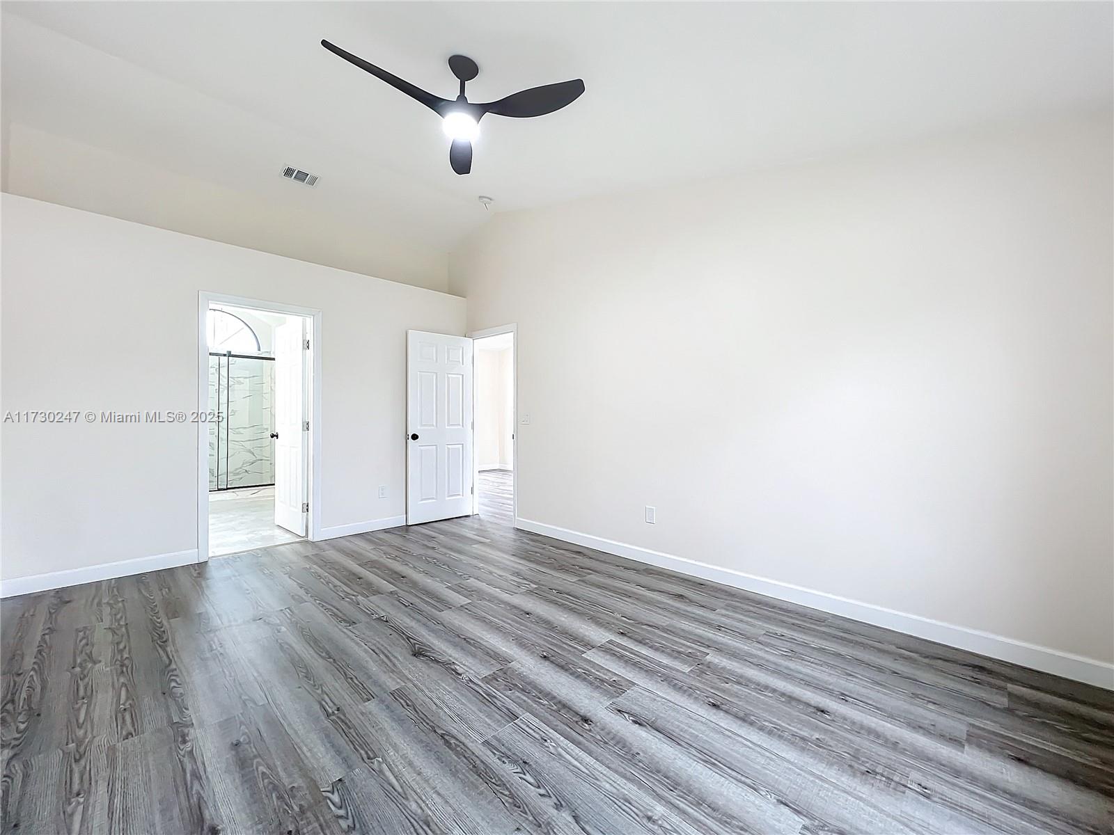521 Southwest Rabbit Avenue Port St. Lucie, FL 34953 - Photo 33 of 45 a view of empty room with wooden floor and fan