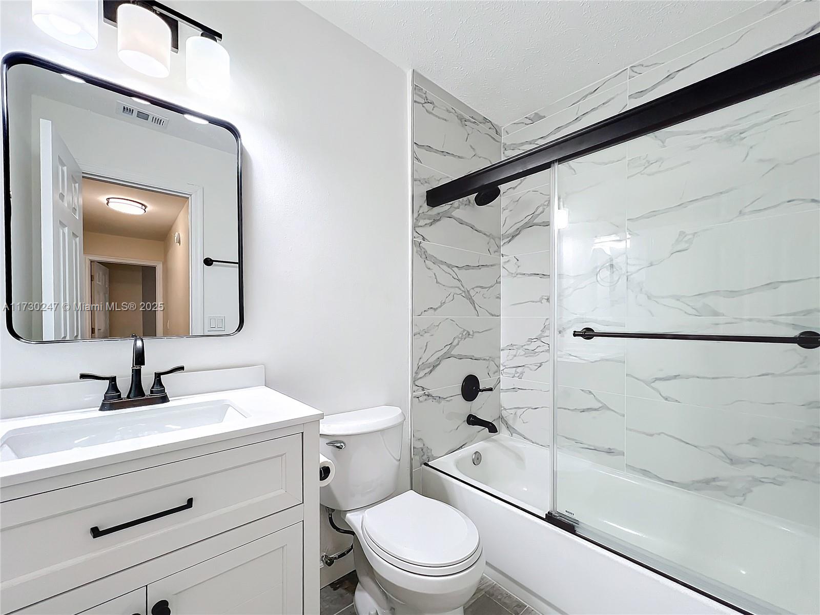 521 Southwest Rabbit Avenue Port St. Lucie, FL 34953 - Photo 43 of 45 a bathroom with a sink a toilet and shower