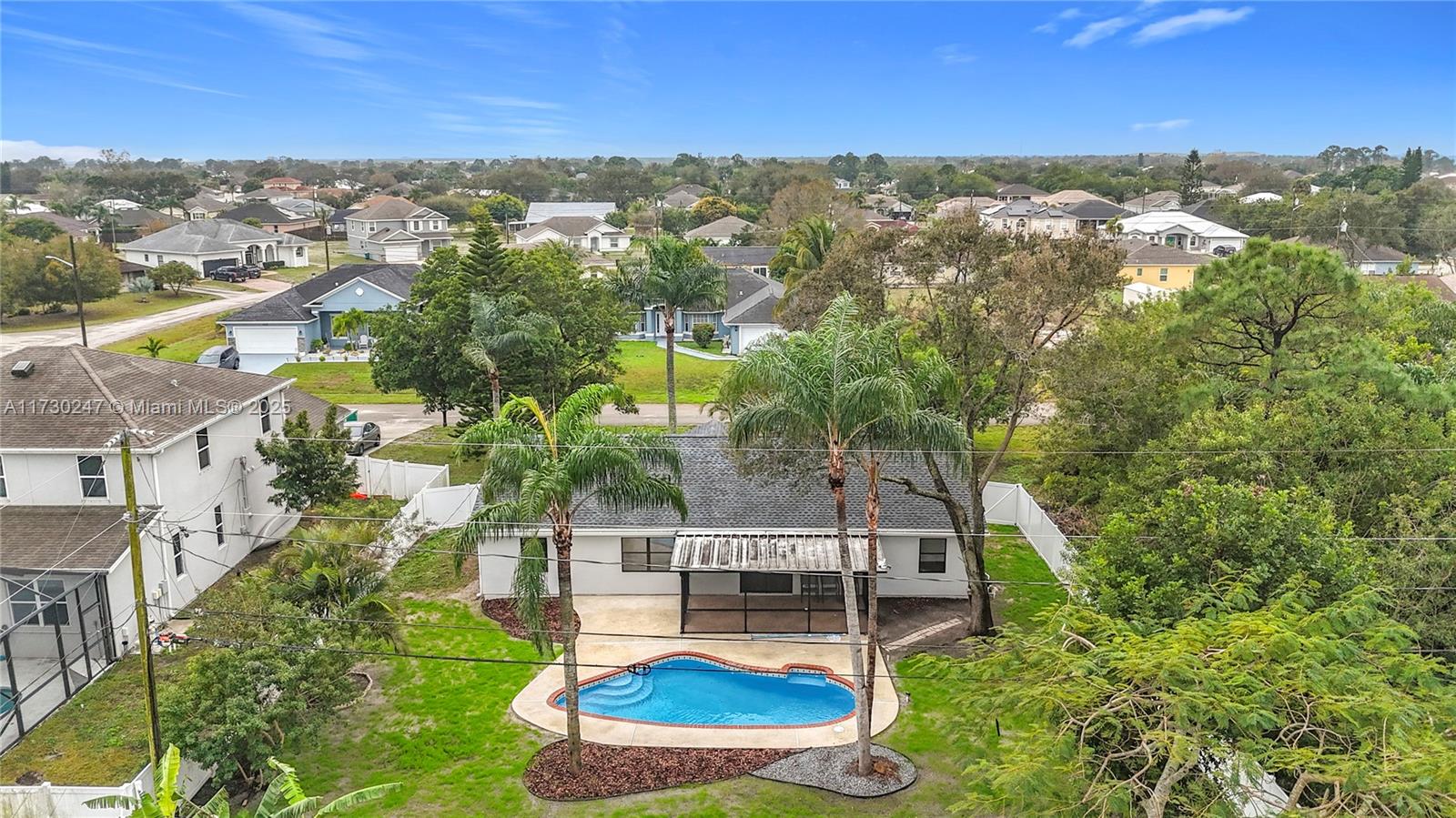 521 Southwest Rabbit Avenue Port St. Lucie, FL 34953 - Photo 5 of 45 an aerial view of residential house with outdoor space and trees all around