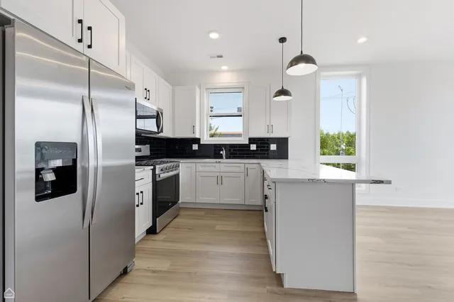 a kitchen with a refrigerator and a sink