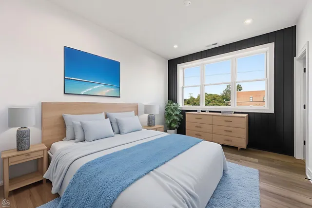 a bedroom with a large bed and a large window