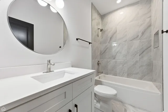 a bathroom with a sink a toilet and a mirror