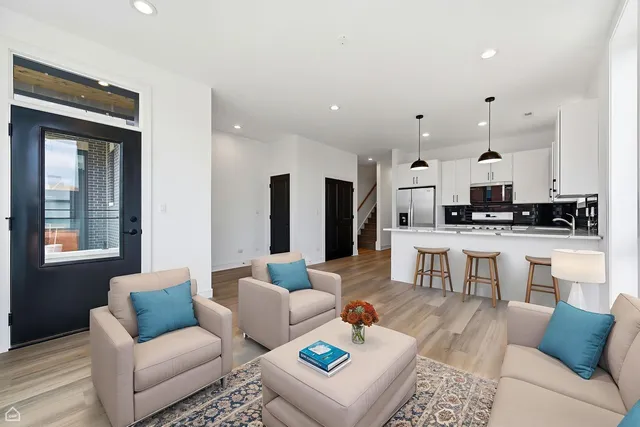 a living room with furniture and kitchen view