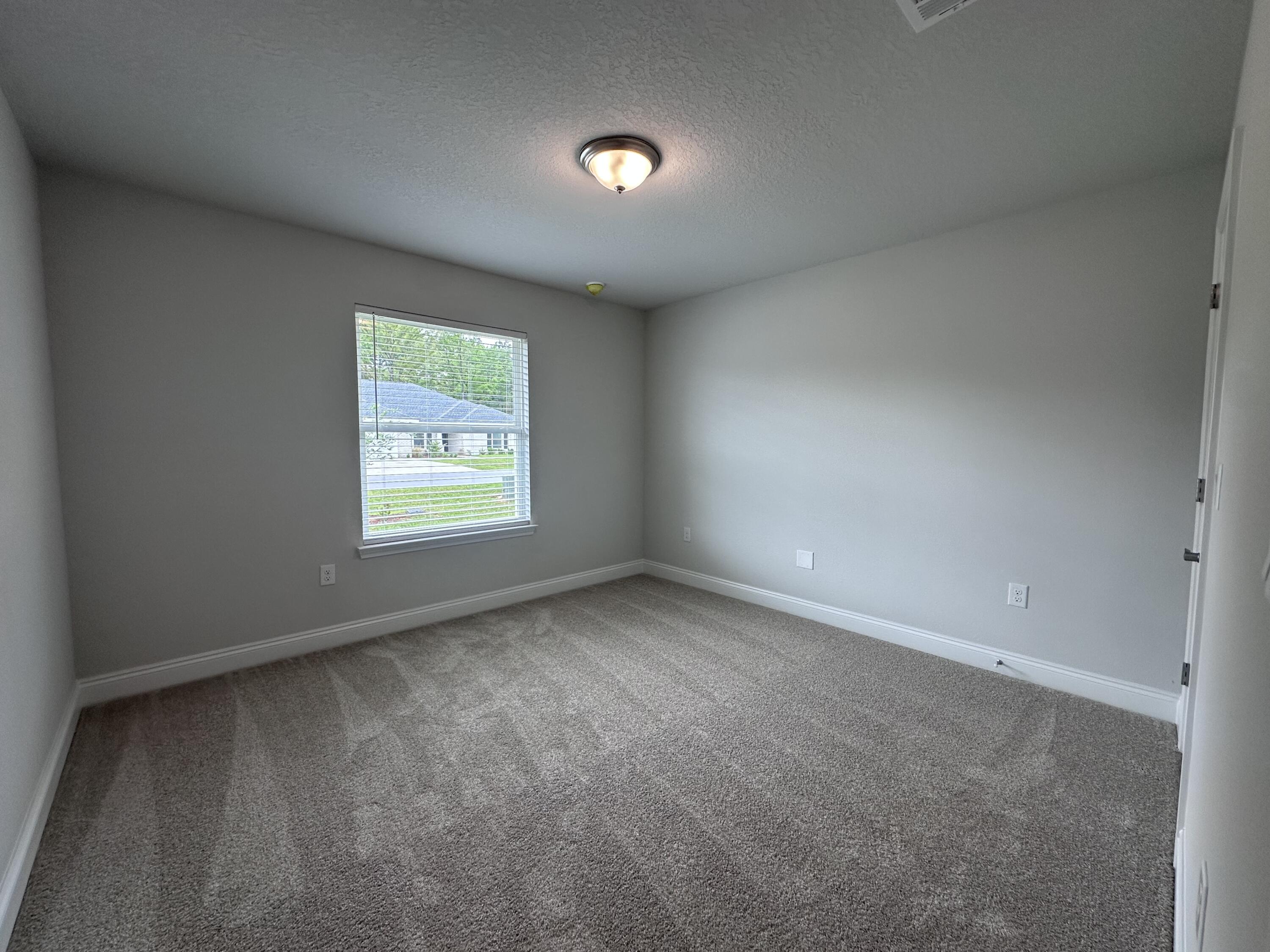 6114 Buckshot Drive Crestview, FL 32539 - Photo 15 of 22 an empty room with windows