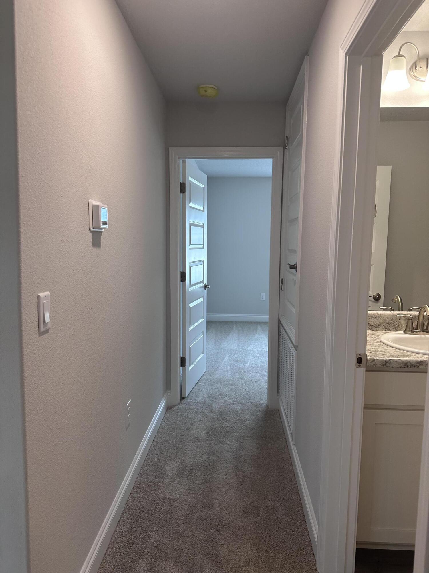 6114 Buckshot Drive Crestview, FL 32539 - Photo 16 of 22 a view of a hallway with wooden cabinets