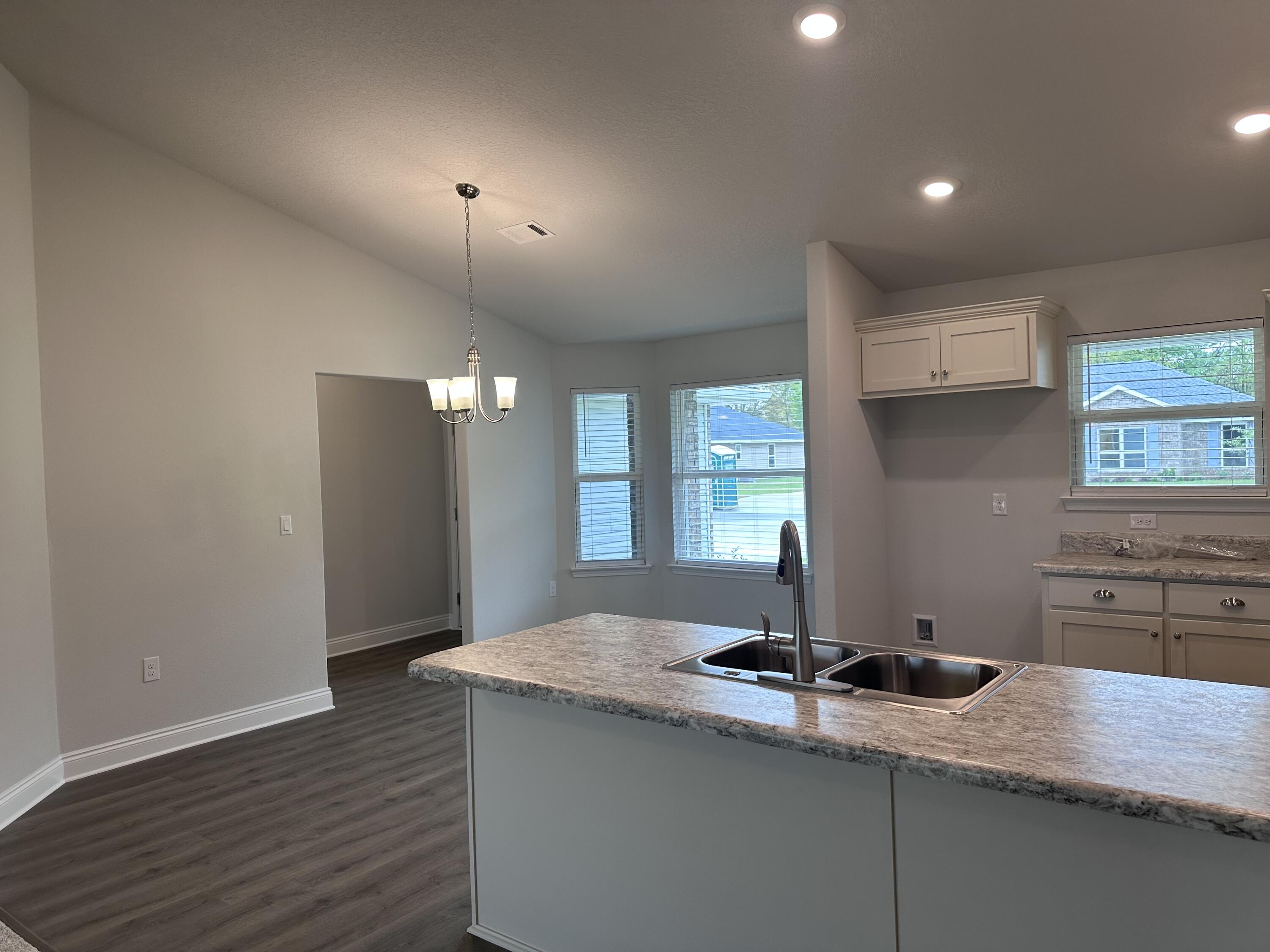 6114 Buckshot Drive Crestview, FL 32539 - Photo 18 of 22 a view of a kitchen with a sink and wooden floor