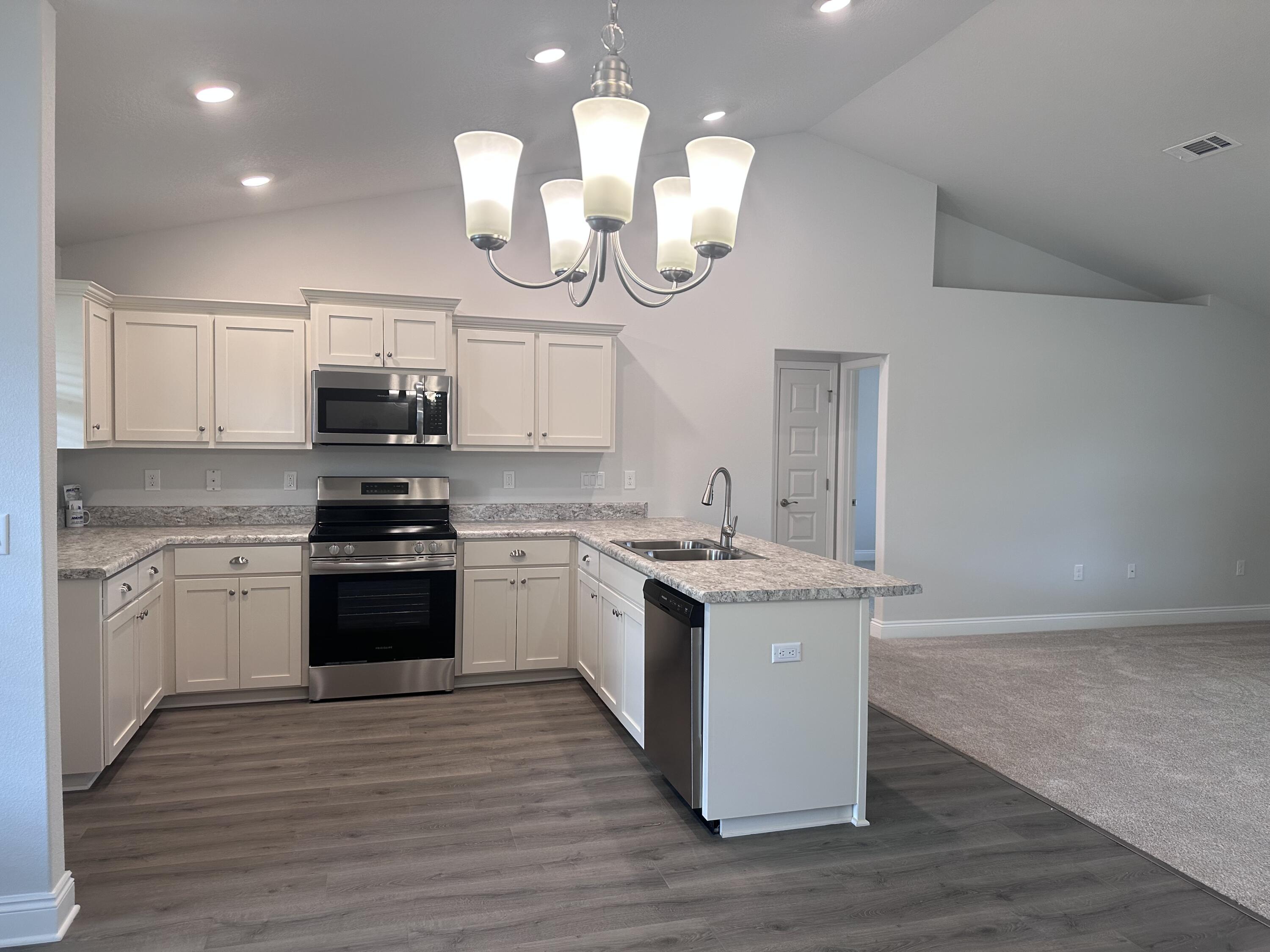 6114 Buckshot Drive Crestview, FL 32539 - Photo 20 of 22 a kitchen with a sink and a stove top oven