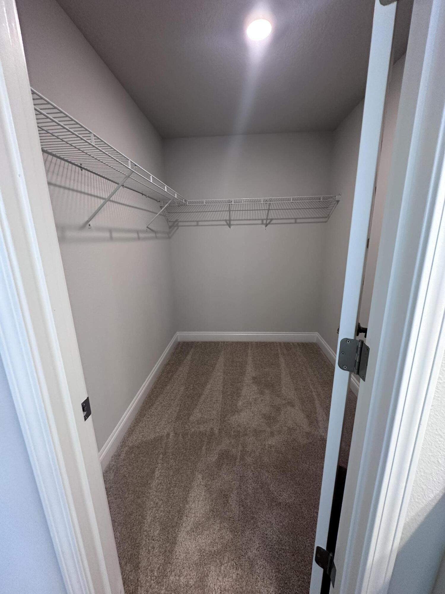 6114 Buckshot Drive Crestview, FL 32539 - Photo 5 of 22 a view of a room with racks on the wall