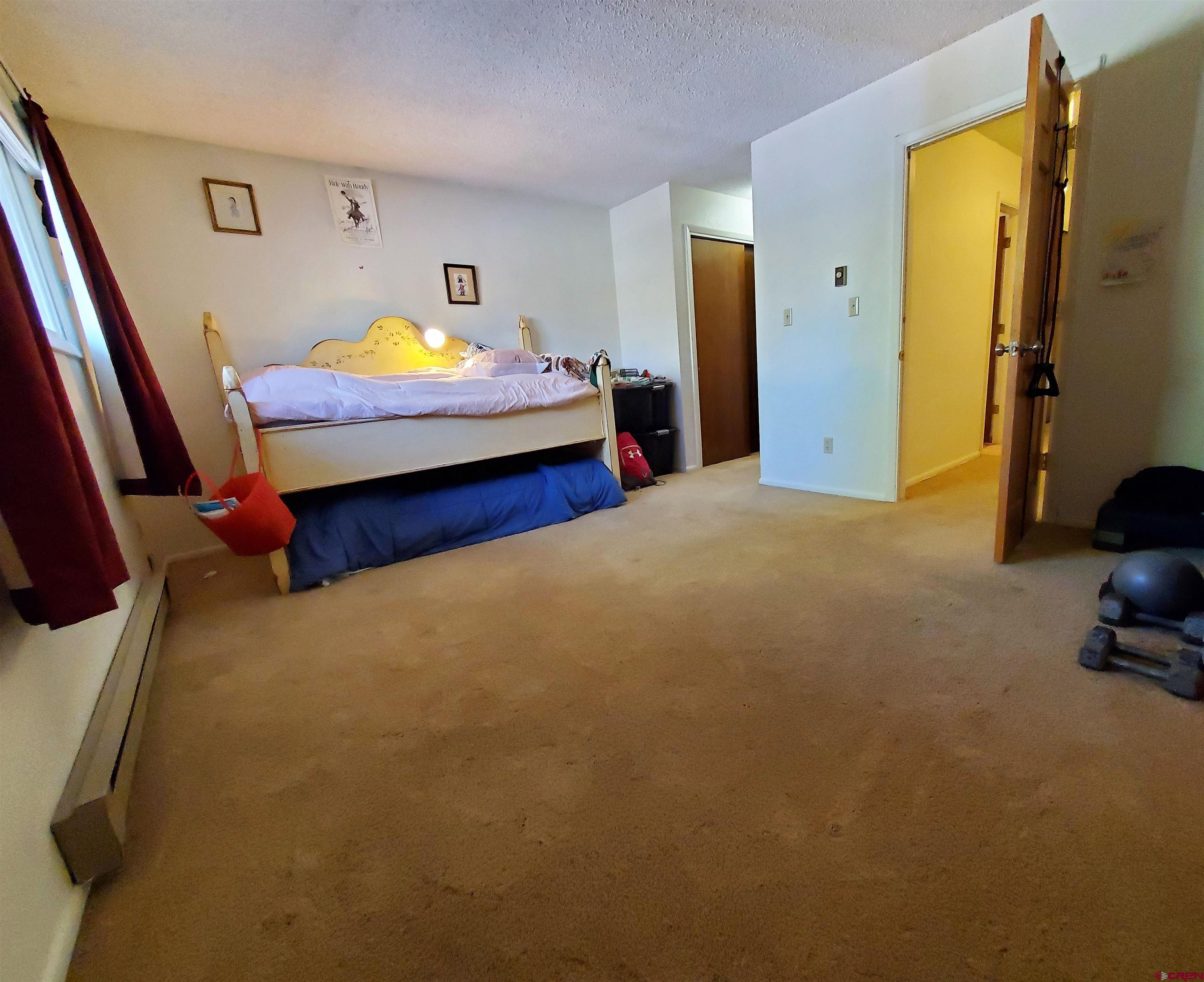 1825 Florida Road, Unit 103 Durango, CO 81301 - Photo 16 of 34 a bedroom with a bed and wooden floor