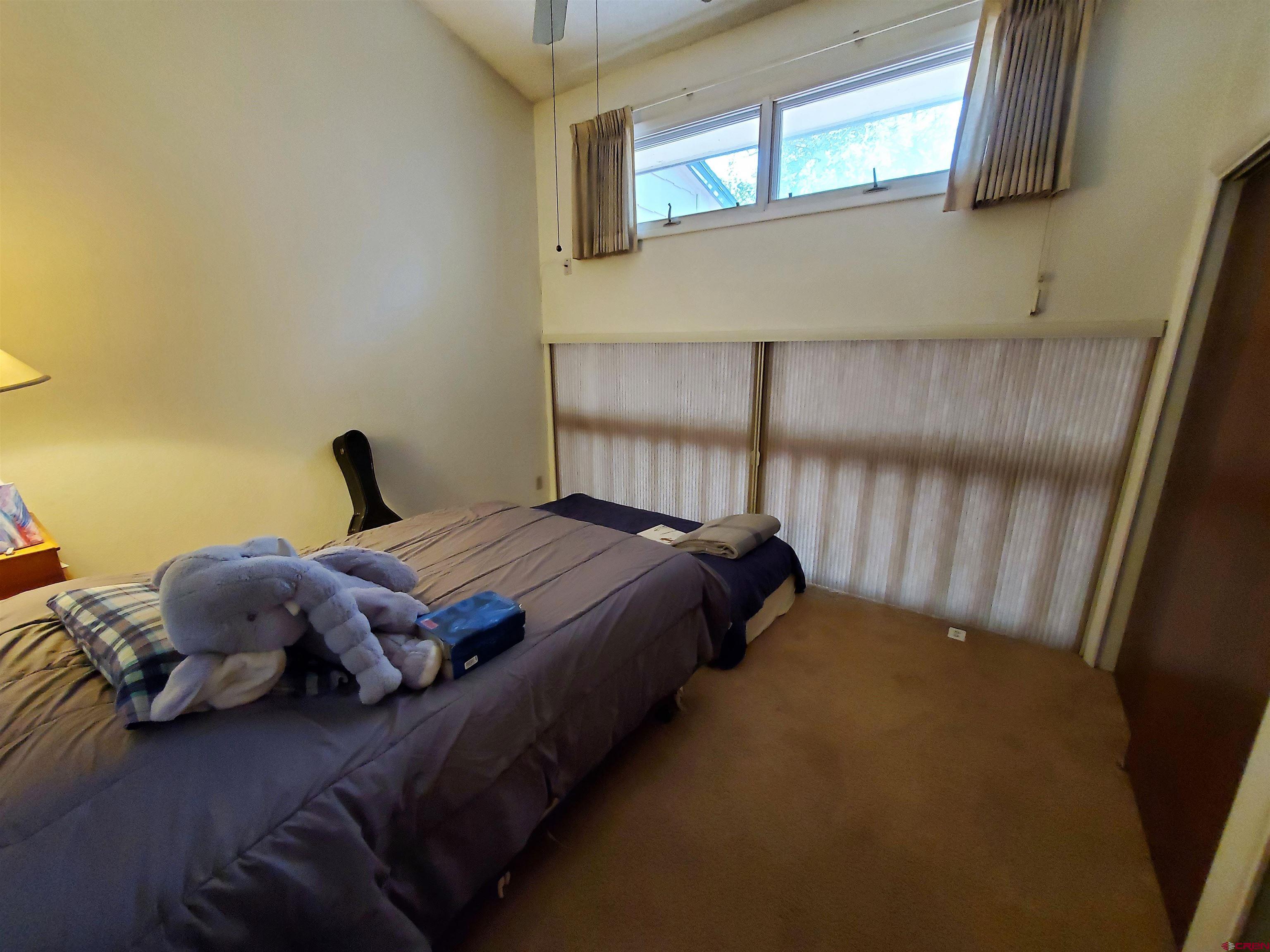 1825 Florida Road, Unit 103 Durango, CO 81301 - Photo 25 of 34 a bedroom with a bed and window