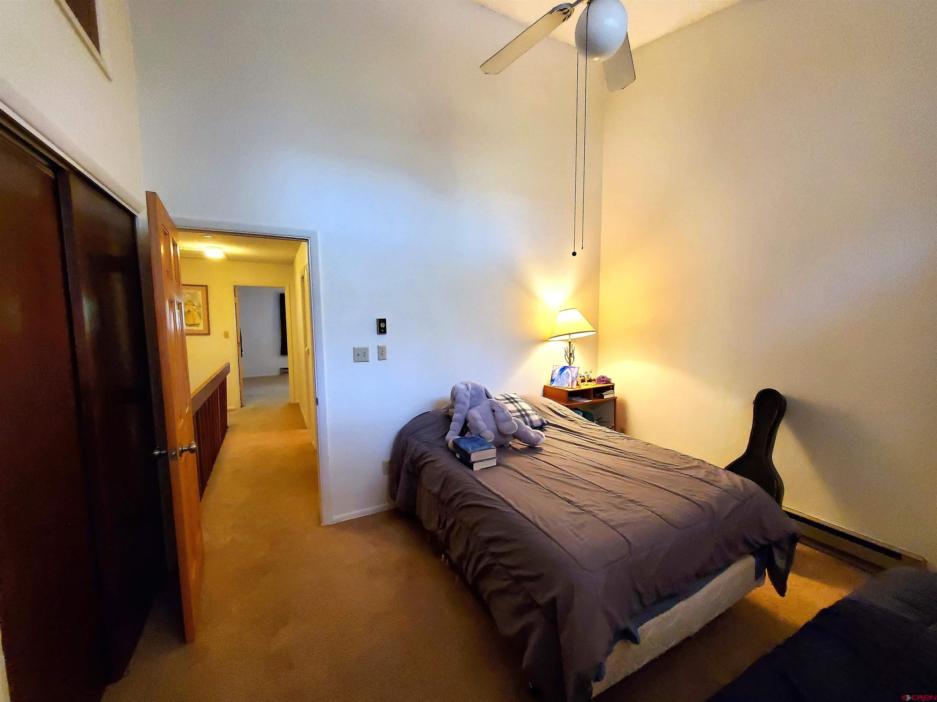 1825 Florida Road, Unit 103 Durango, CO 81301 - Photo 26 of 34 a bedroom with a bed and a chandelier