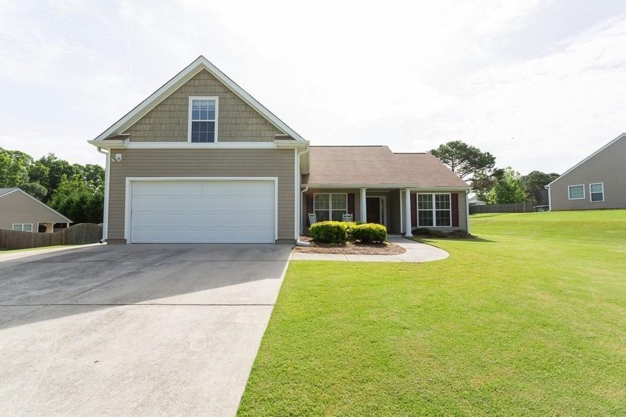 a front view of house with yard and swimming pool