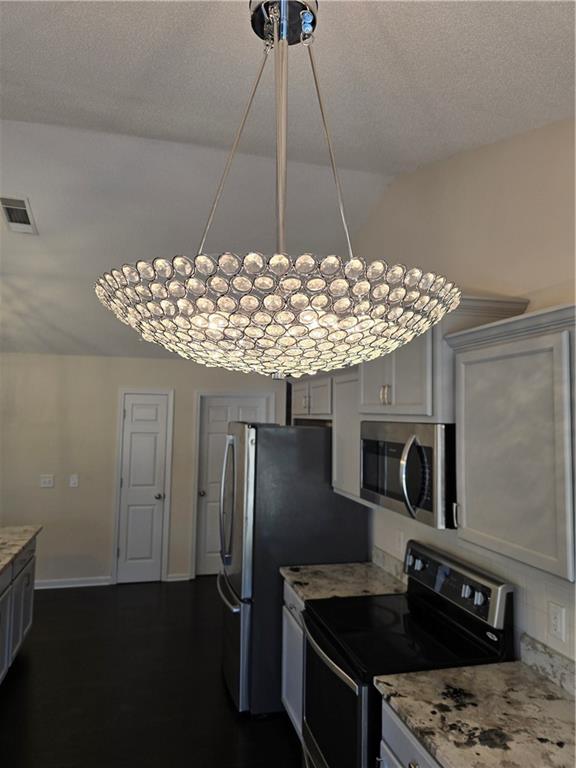 607 McDowell Lane Bethlehem, GA 30620 - Photo 11 of 22 a kitchen with stainless steel appliances granite countertop a sink and a stove