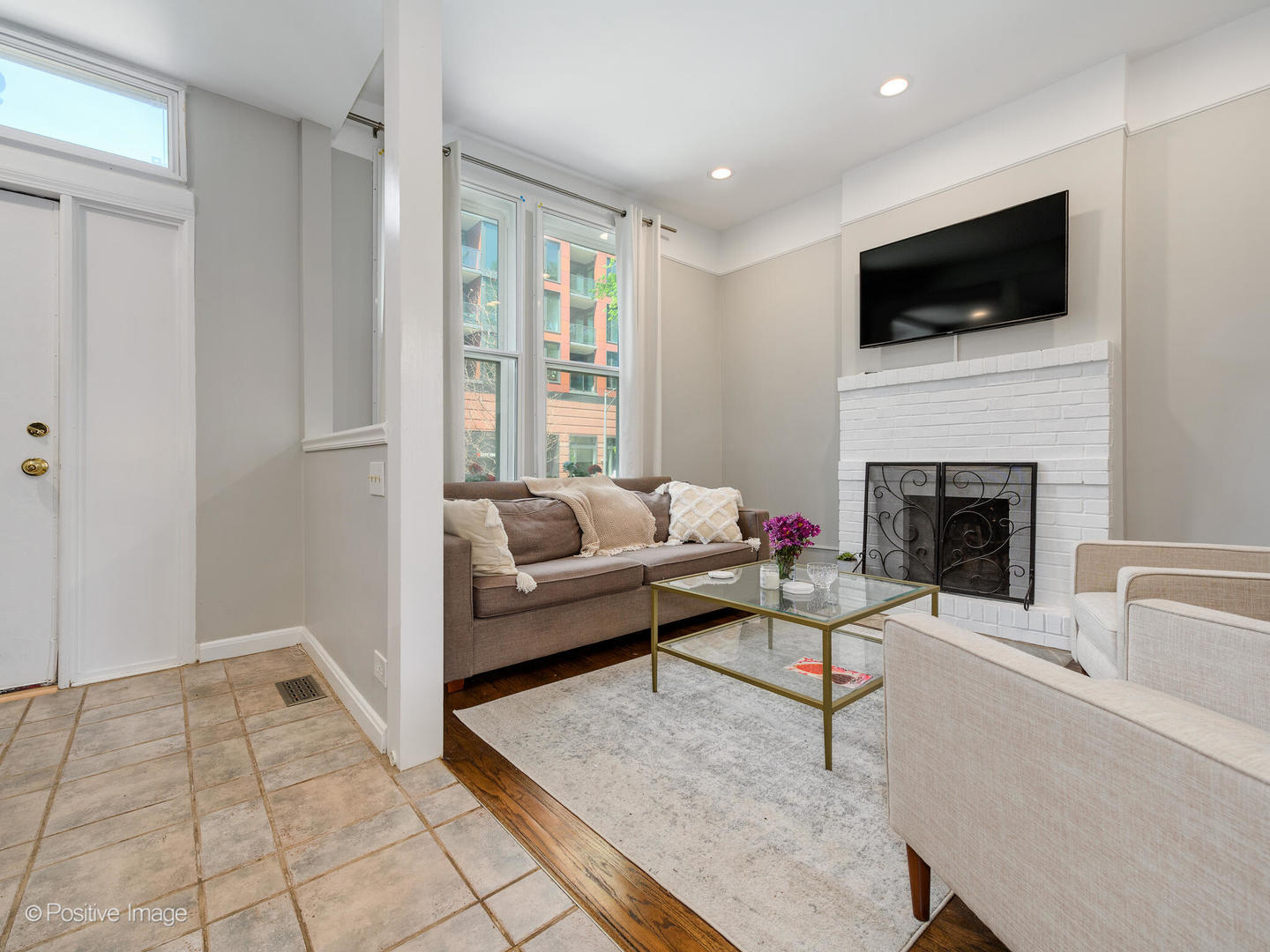 941 West Altgeld Street Chicago, IL 60614 - Photo 4 of 18 a living room with furniture a flat screen tv and a fireplace