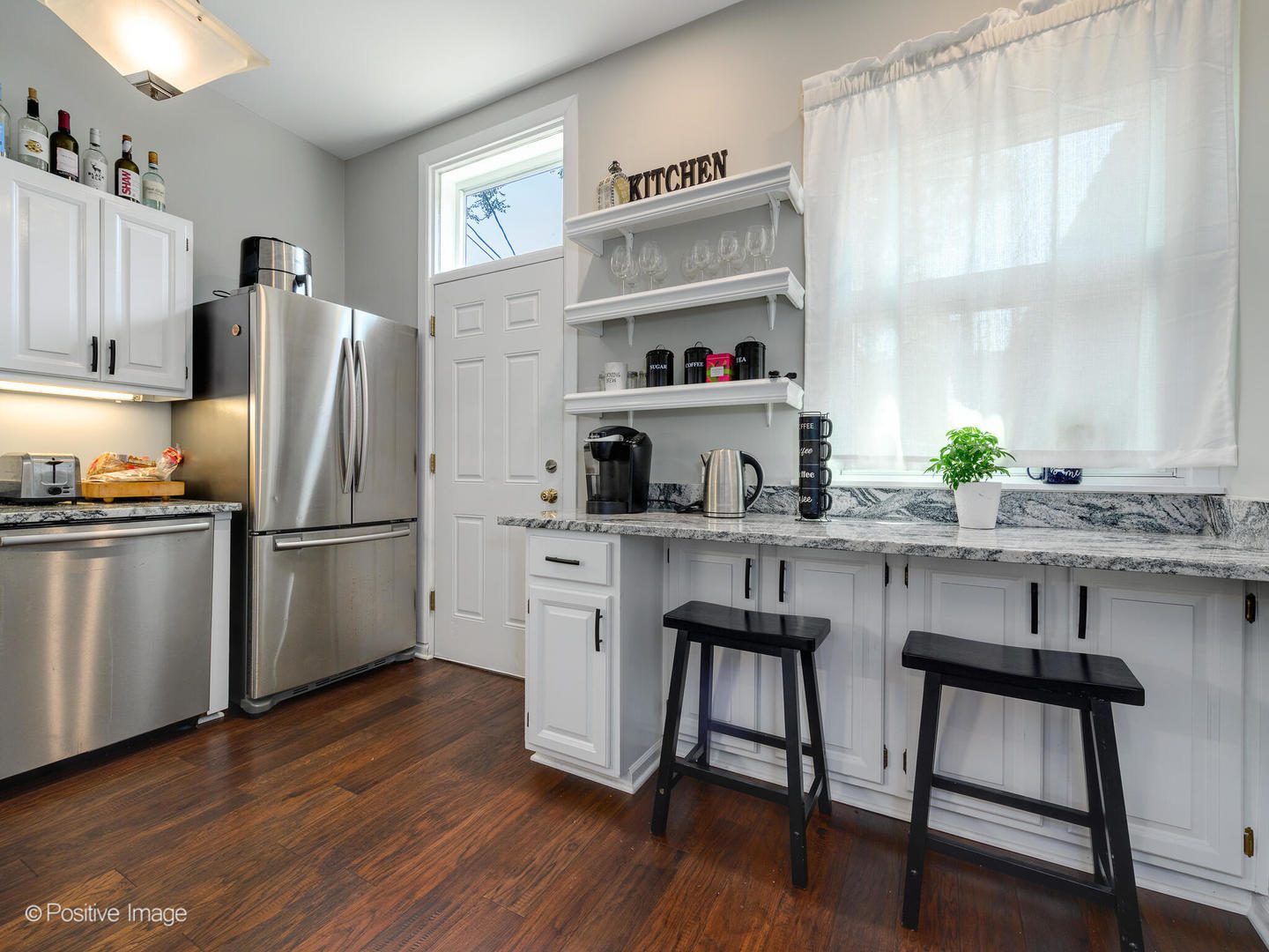 941 West Altgeld Street Chicago, IL 60614 - Photo 8 of 18 a kitchen with stainless steel appliances a dining table chairs refrigerator and sink