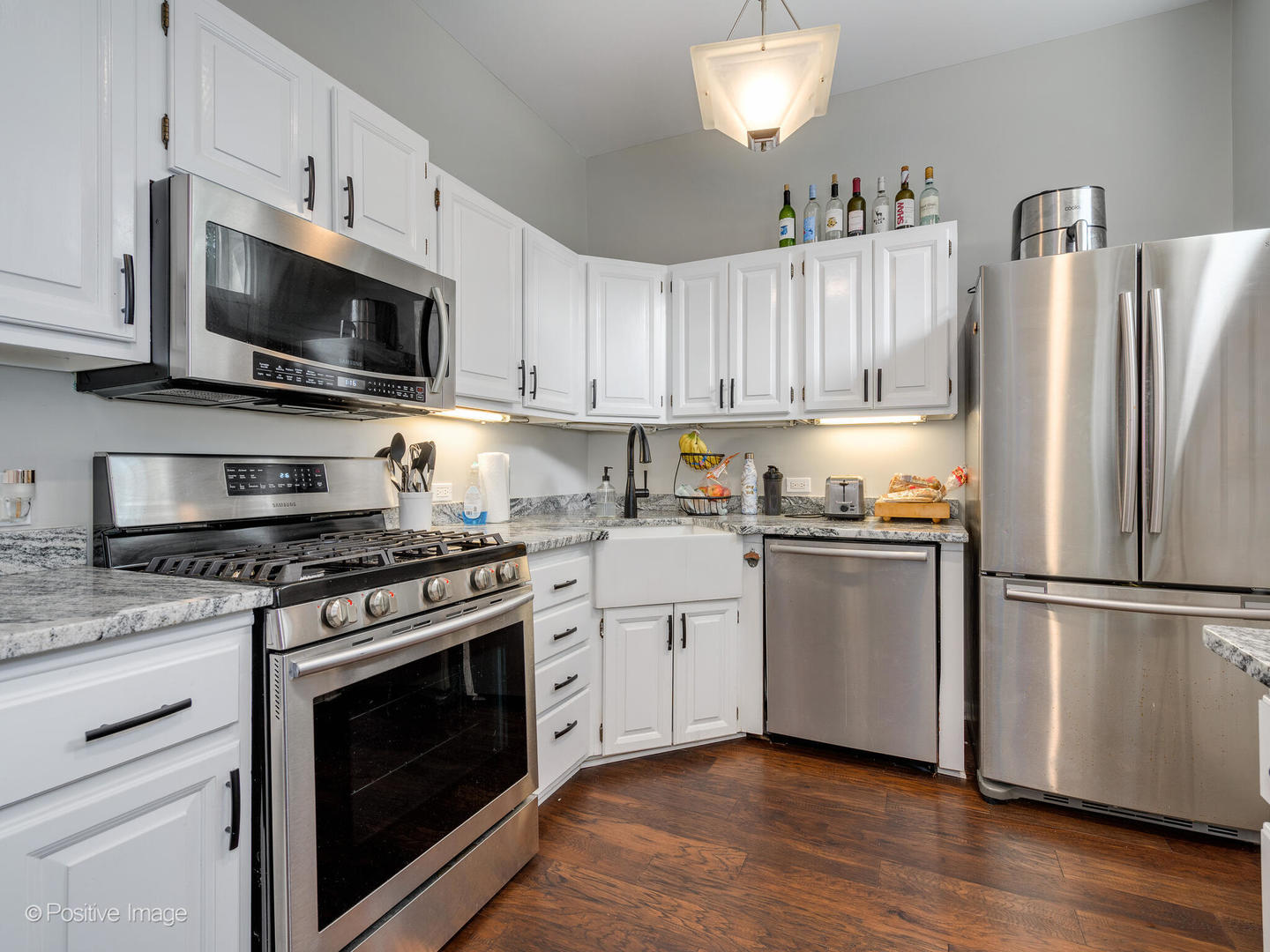 941 West Altgeld Street Chicago, IL 60614 - Photo 9 of 18 a kitchen with cabinets stainless steel appliances a sink and wooden floor
