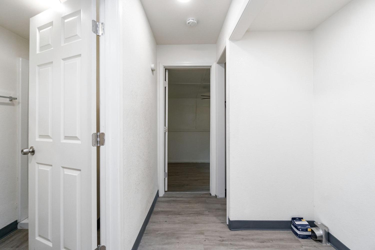46801 Dunlap Road Miramonte, CA 93641 - Photo 14 of 28 a view of a hallway with closet and wooden floor