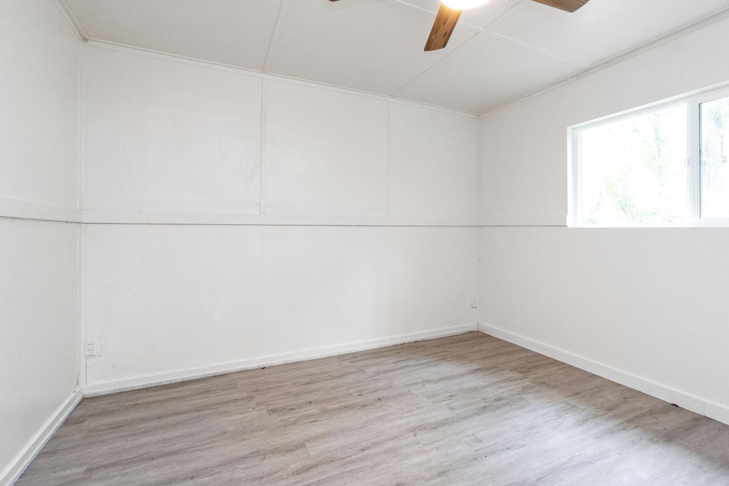 46801 Dunlap Road Miramonte, CA 93641 - Photo 17 of 28 an empty room with wooden floor and windows