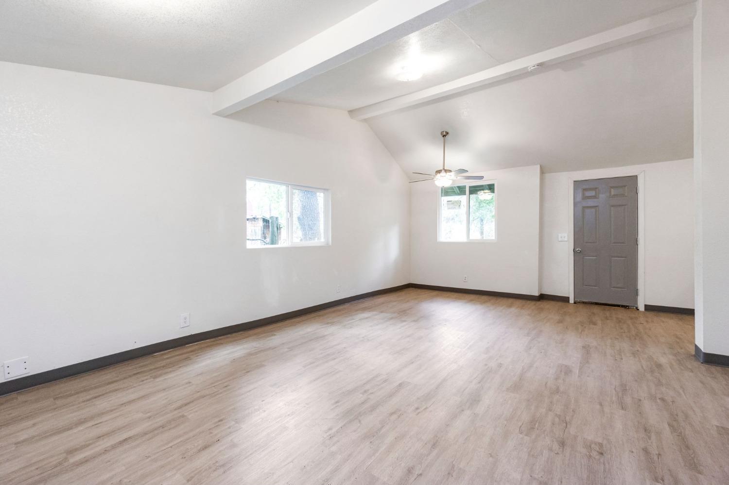 46801 Dunlap Road Miramonte, CA 93641 - Photo 4 of 28 an empty room with wooden floor and windows